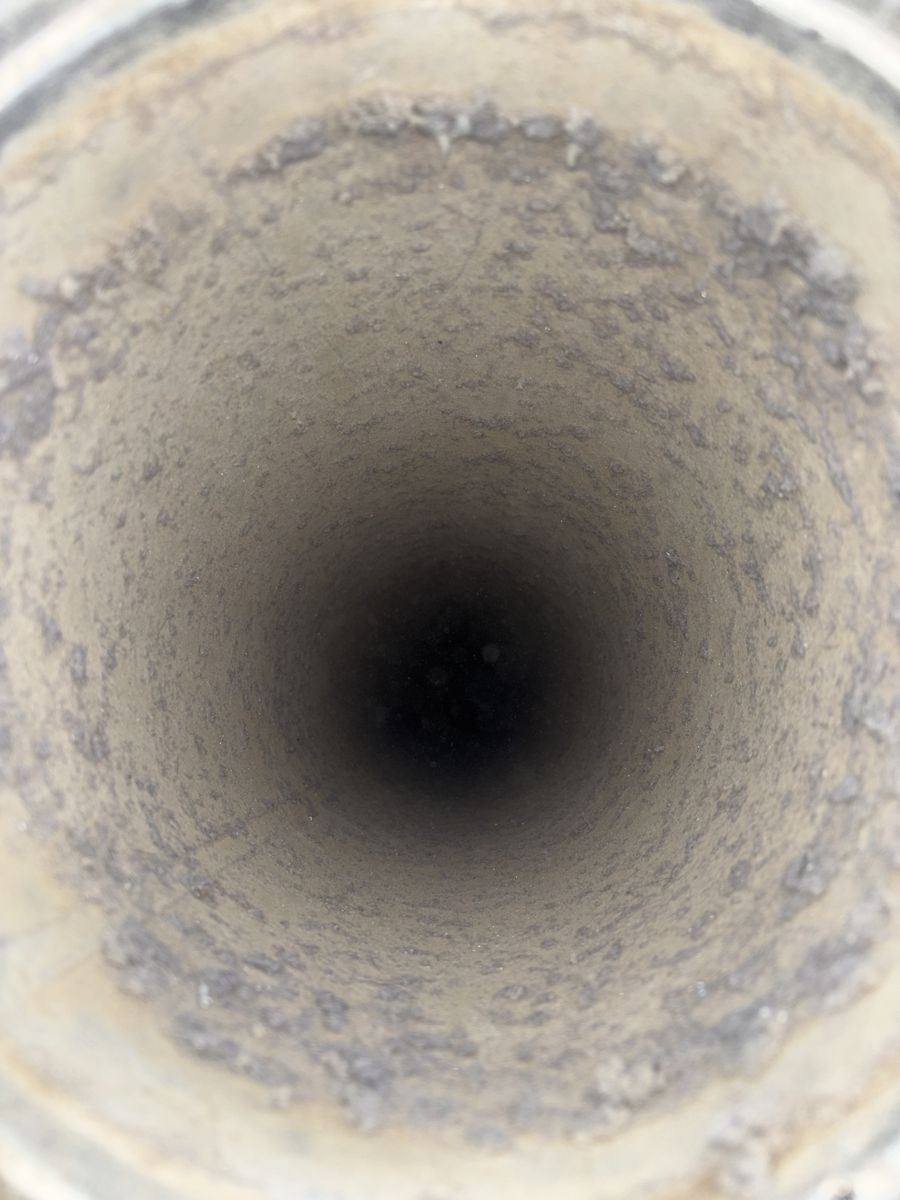 Dryer vent pipe with lint stuck around the walls before cleaning