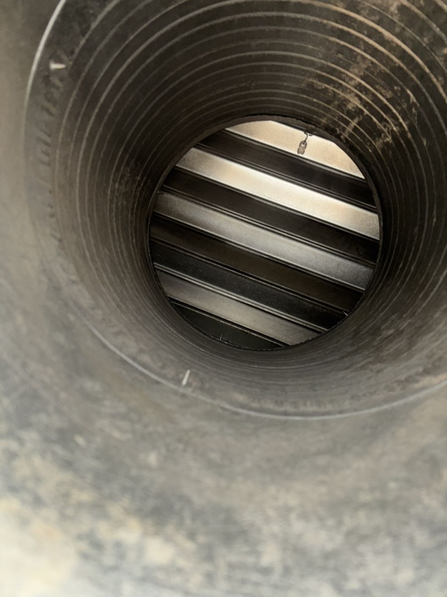 The same spiral furnace duct after cleaning, bare metal