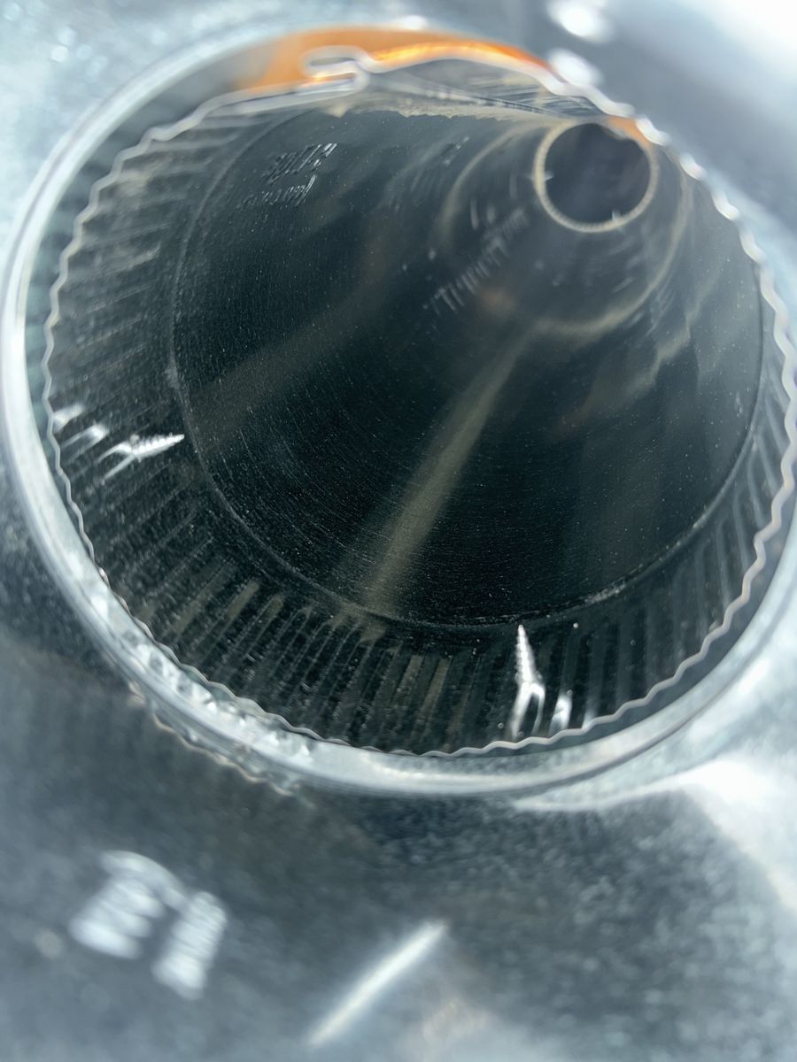 The same round duct after cleaning, clean metal to the far end