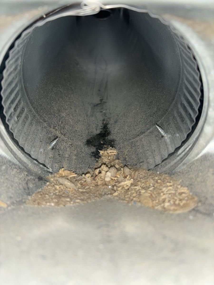 Duct takeoff with sawdust and dust before cleaning