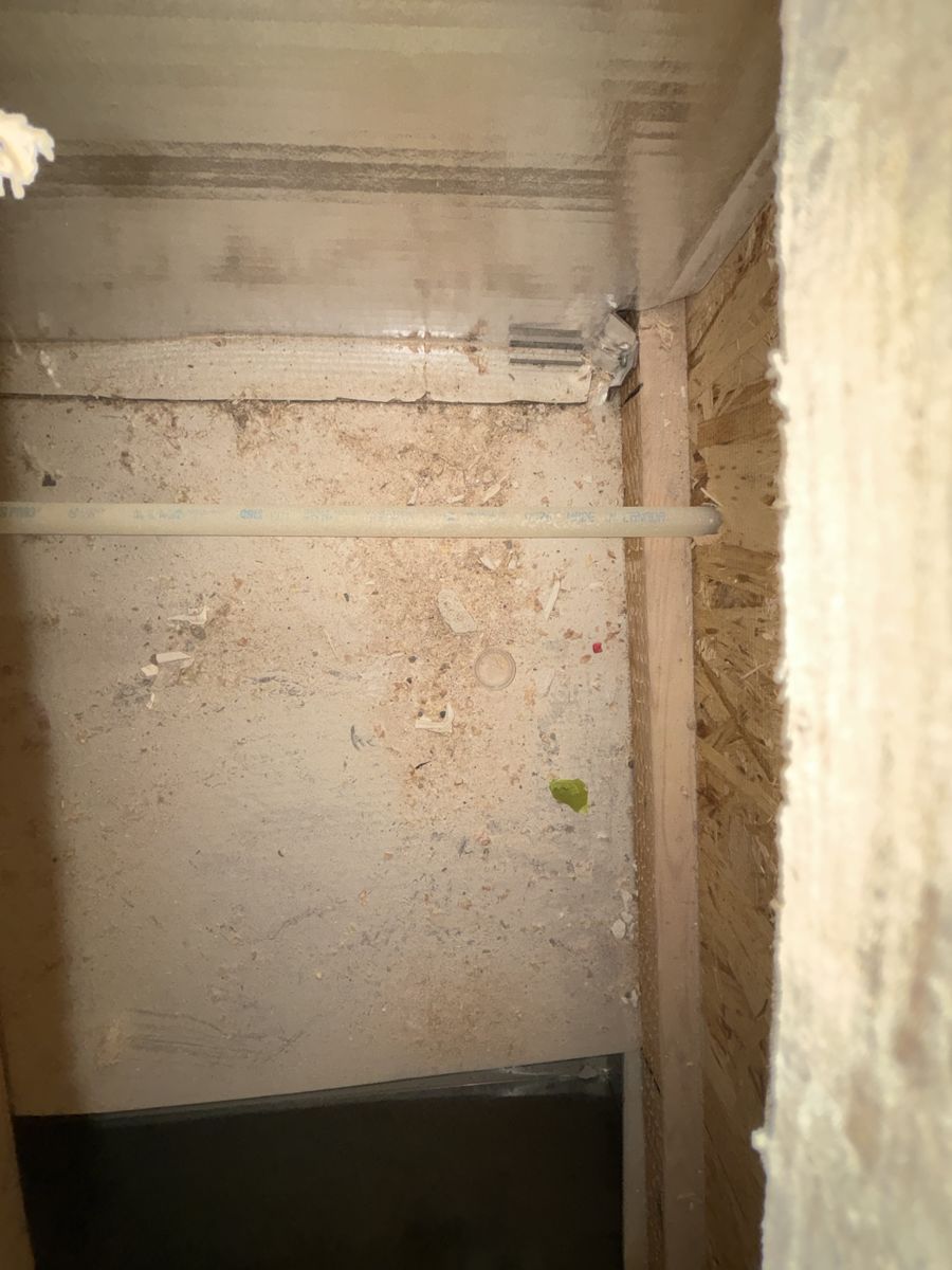 Duct panel covered in sawdust before cleaning