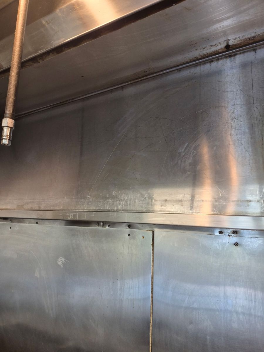 The same kitchen hood wall after cleaning, clean steel