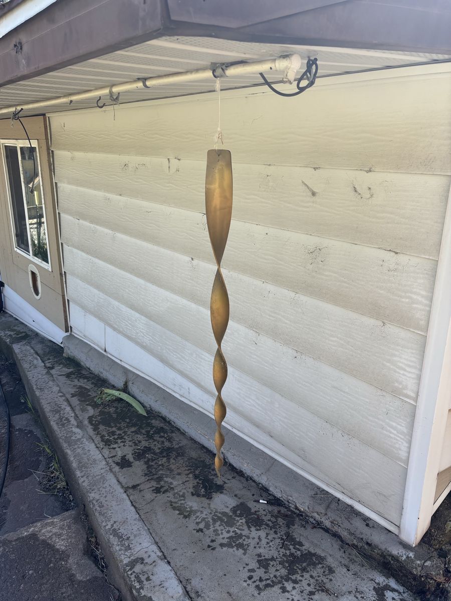 House siding with dark spots and dirt marks before a soft wash