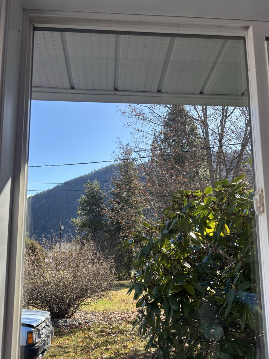 The same window after cleaning, a clear view of the yard and hills